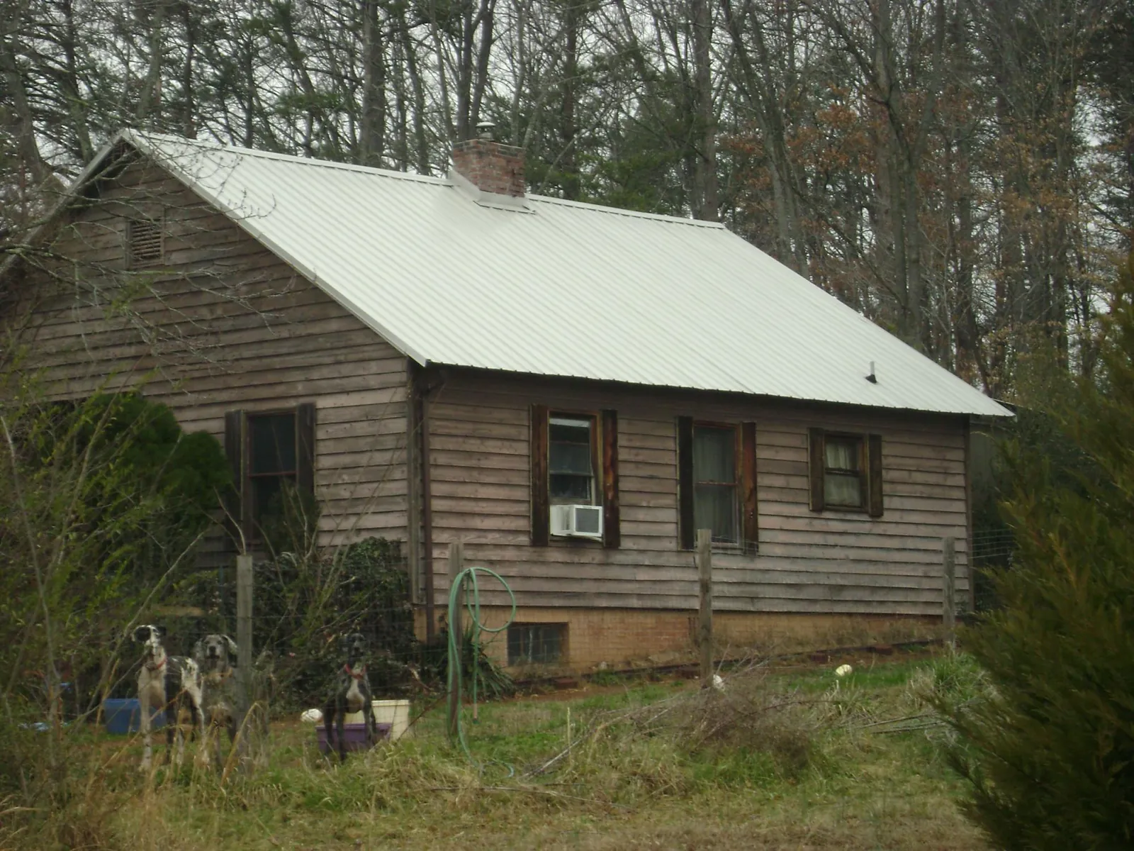 White metal roof on an old wood sided farmhouse, from a Metal Roof Installation job in Bethpage